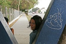 Young girls sit at the urban transport stop. Habana, Cuba, Saturday, March 10, 2007.