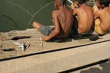 Children fish with a fishing-line. In small towns free of tourists the rate of life is quite different. Baracoa, Cuba, Saturday, March 3, 2007.