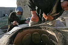 Making bread in the village not far from the Turkmenian frontier. Shirvan, Iran, Thursday, April 20, 2006.