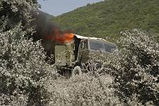 A moment after the bombardment of the convoy by the Georgian aircraft on the road from Tshinvali to Russia.  A truck on fire. Monday August 11, 2008. 