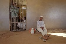 The victim in waiting near the suspect's prison cell. The police station El Imam Malik in the Omdurman, the suburb of the capital. Khartoum, Sudan. Monday, Dec. 22, 2003.