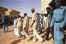The suspects are escorted to the police wagon to go to the court. The police station El Imam Malik in the Omdurman, the suburb of the capital. Khartoum, Sudan. Monday, Dec. 22, 2003.