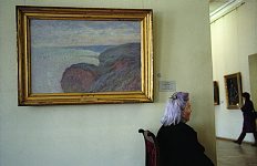 Claude Monet. The museum custodian in the State Hermitage Museum, St.Petersburg, Russia, May, 2003.