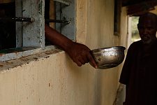 A patient of the mental hospital thrusting out his pot and waiting for his turn to get dinner. Hargeisa, SomaliLand, Monday, October 8, 2007. The only mental hospital in the country has a male and a female wards with about a hundred patients altogether.