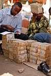 Street money changers at work. Hargeisa, SomaliLand, Saturday, September 29, 2007. The largest denomination bank note in the country - 500 shillings - is equal to 8 American cents. Besides it 100 and 50 shilling banknotes are in circulation as well.