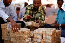 Street money changers at work. Hargeisa, SomaliLand, Saturday, September 29, 2007. The largest denomination bank note in the country - 500 shillings - is equal to 8 American cents. Besides it 100 and 50 shilling banknotes are in circulation as well.