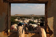 Boys looking out of the window of the ruined state house. Hargeisa, SomaliLand, Sunday, October 7, 2007. The ruins of the former British governor's state house are surrounded now by the refugees camp of the same name.